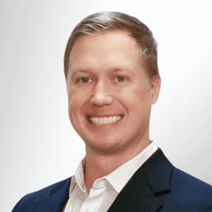 Professional financial advisor in a suit smiling for the camera.
